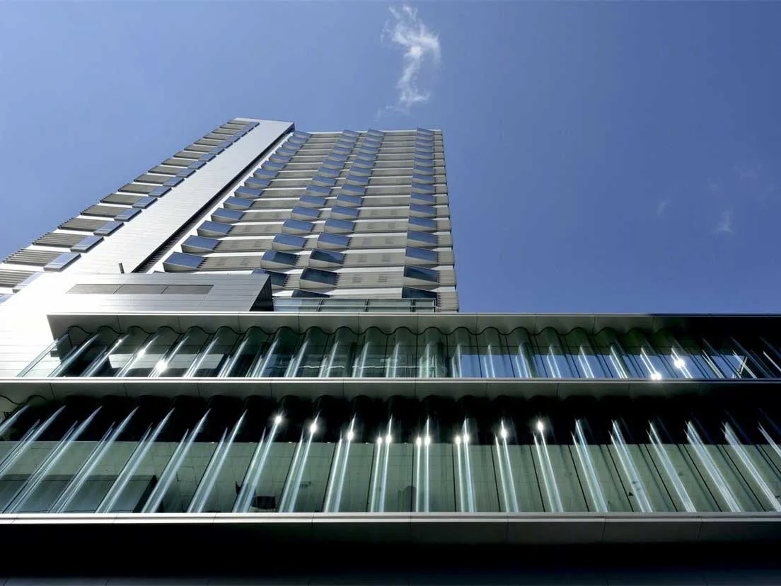 Upward view of the urban hotel tower above the glazed podium