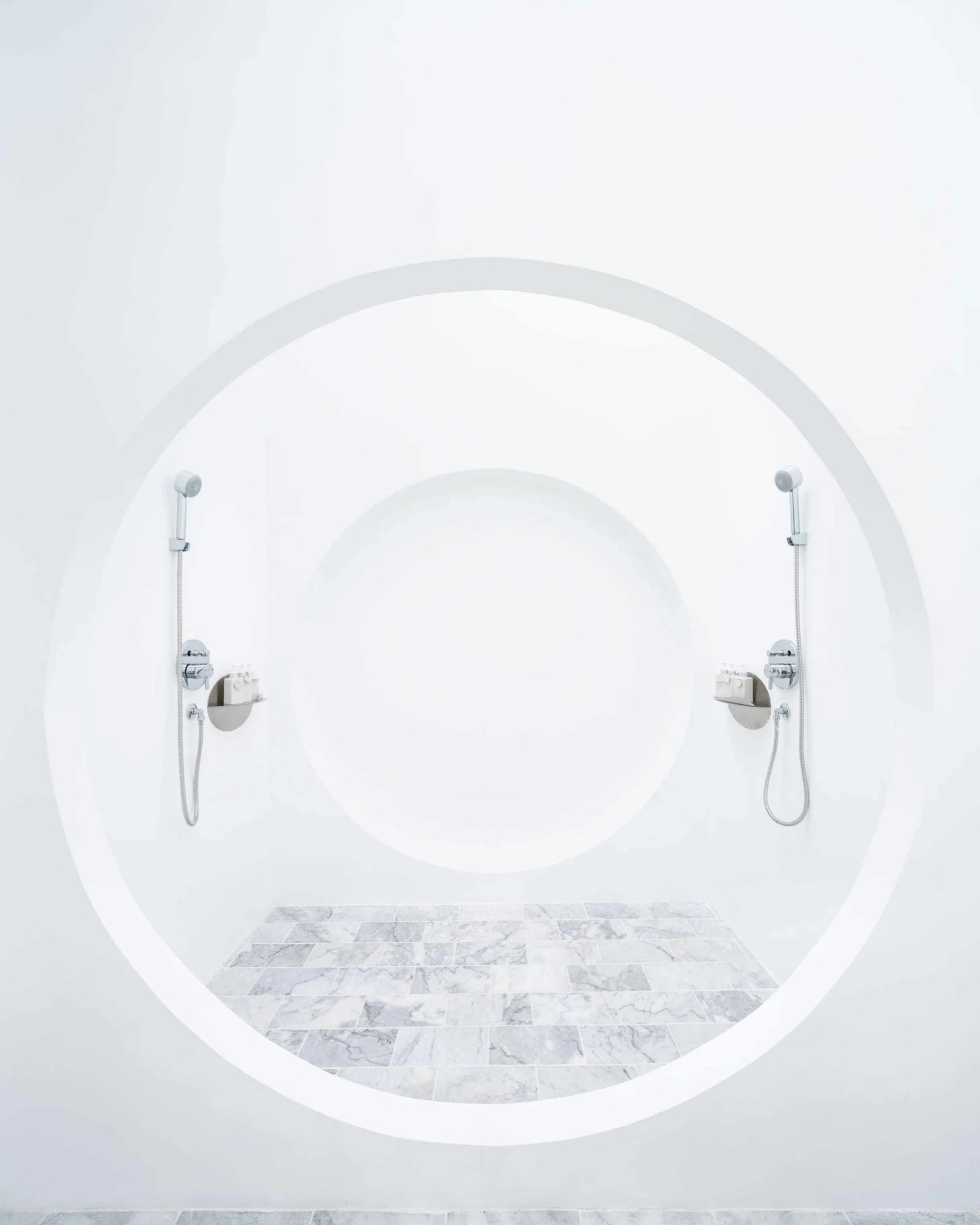 Front view of a circular shower enclosure with two shower fittings