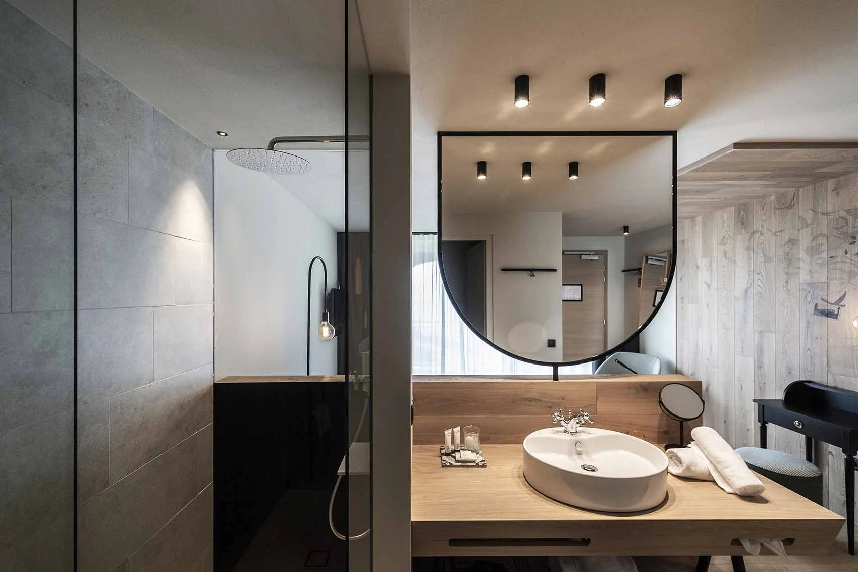 Guest bathroom vanity, round mirror, basin and shower enclosure