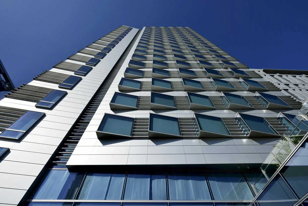 Close upward view of repeated guest-room windows on the tower facade