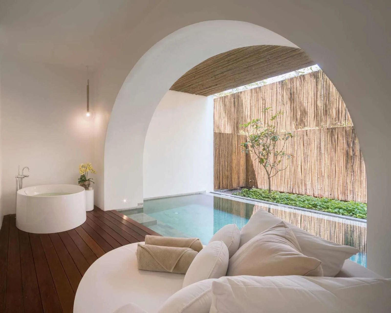 White guest suite with curved opening, round bath and private pool edge