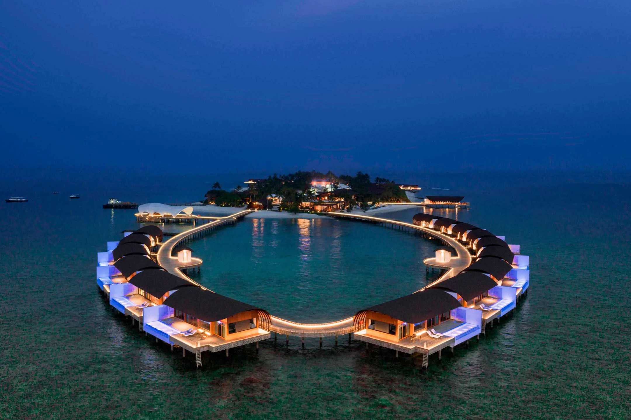 Aerial night view of the island resort arranged around a lagoon