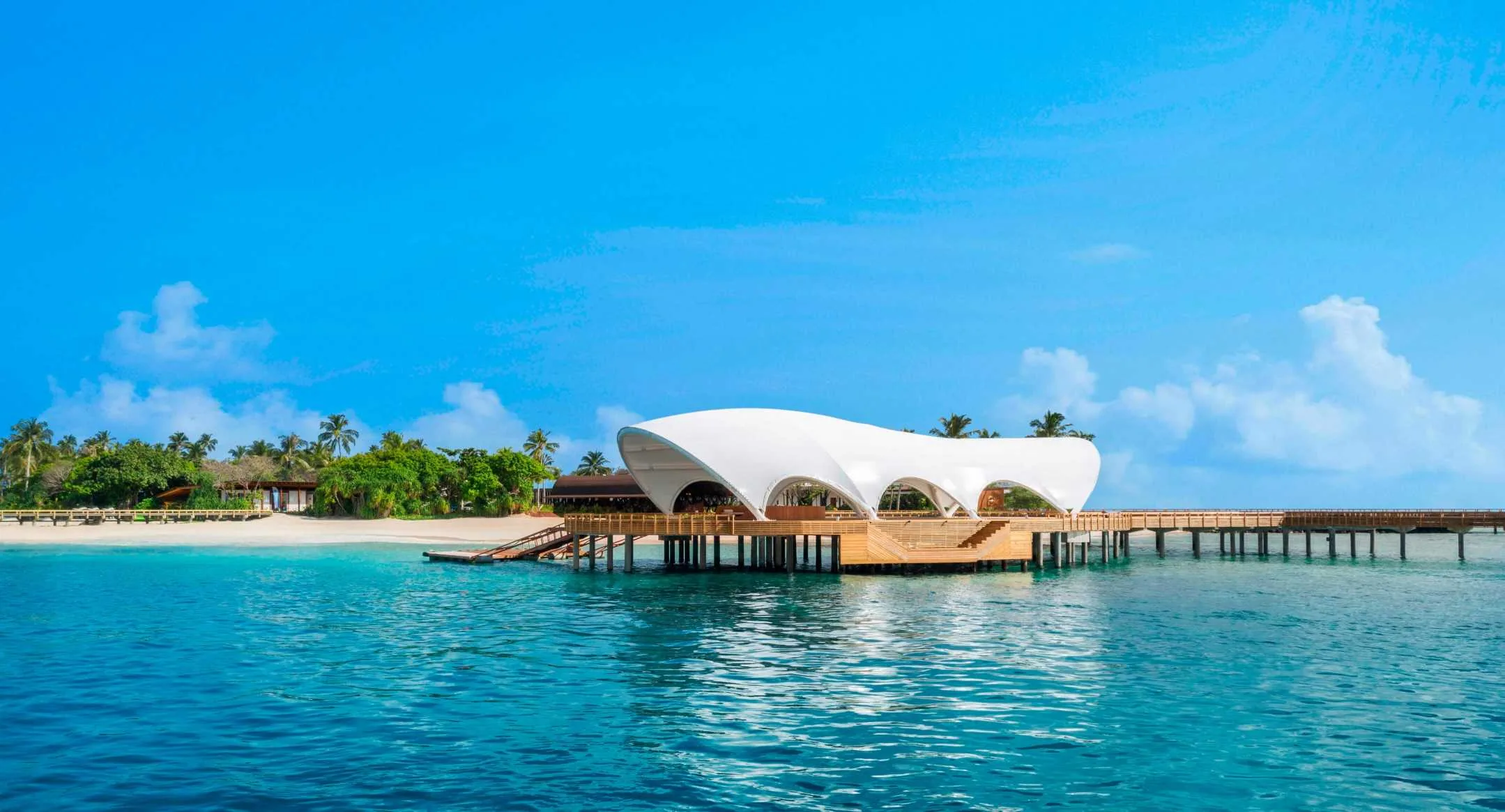 Public resort building viewed across turquoise water