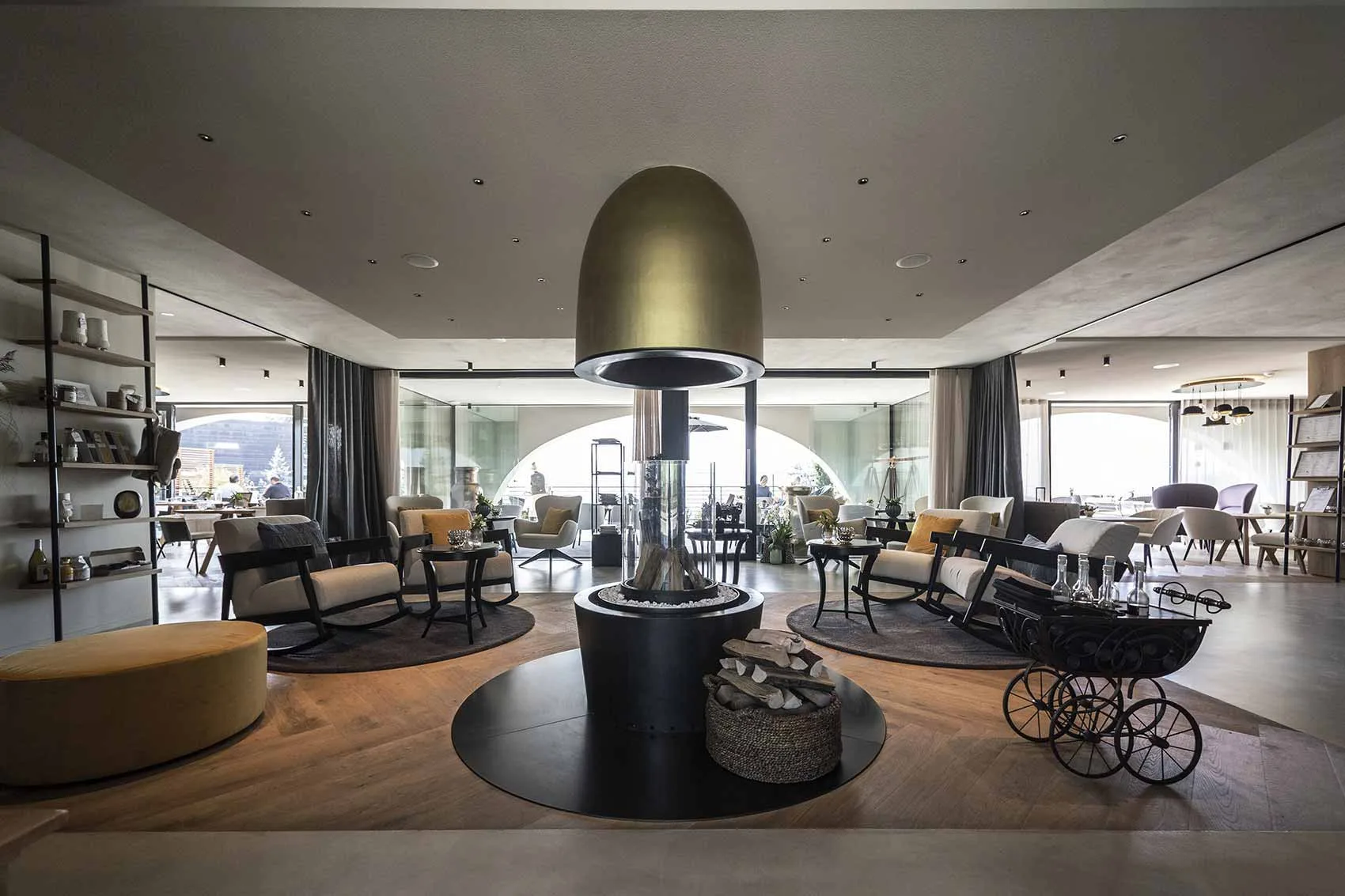 Hotel lounge with mixed seating, display shelving and a central feature light