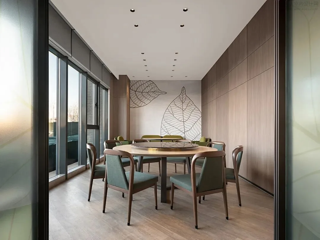 Private dining room with a round table and timber-toned wall panels