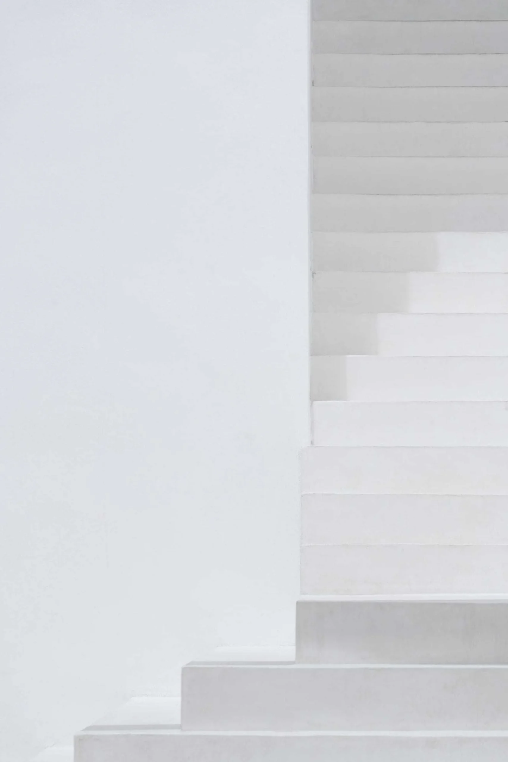 Minimal white stair and arched opening detail