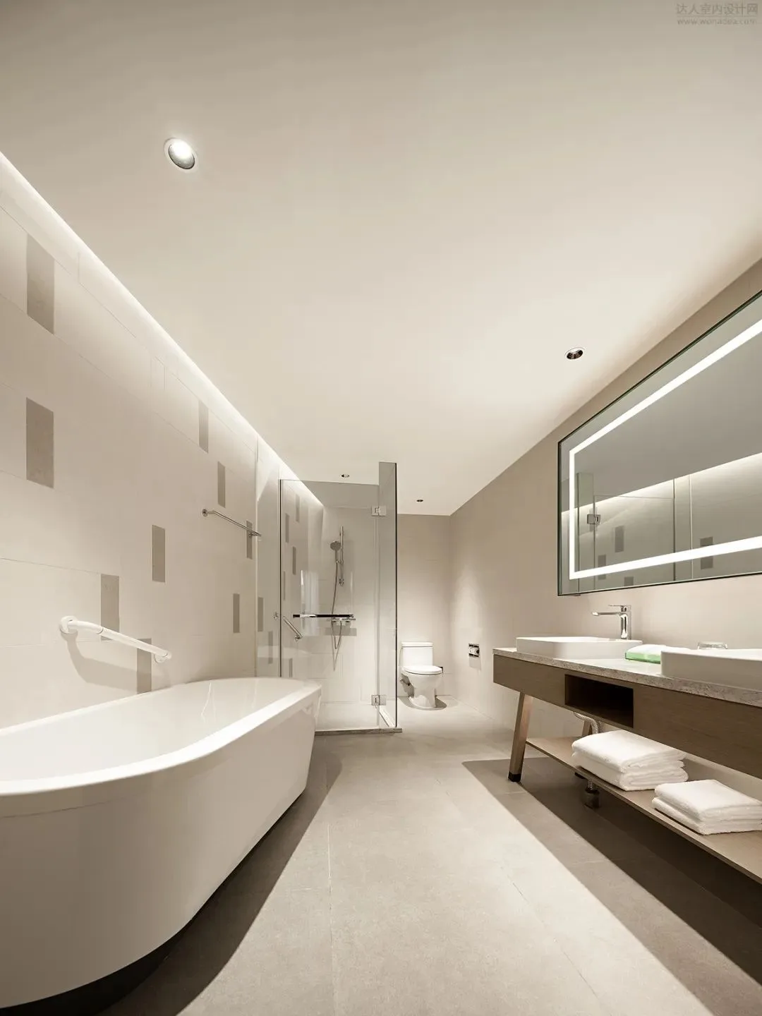 Guest bathroom with a freestanding bath, vanity and illuminated mirror