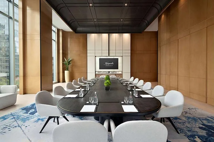 GEORGE Group conference-room visual with a long meeting table and upholstered chairs