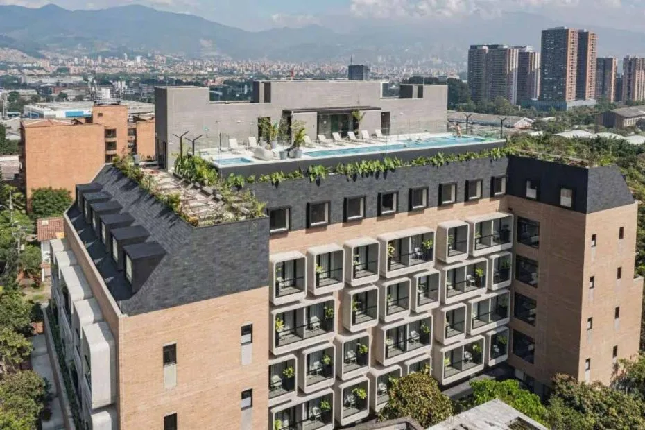 Aerial view of the Landmark Hotel building with repeated guest-room bays, a rooftop leisure area and surrounding city