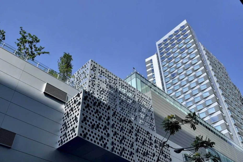 Urban hotel tower and podium with patterned facade panels, glazing and roof planting